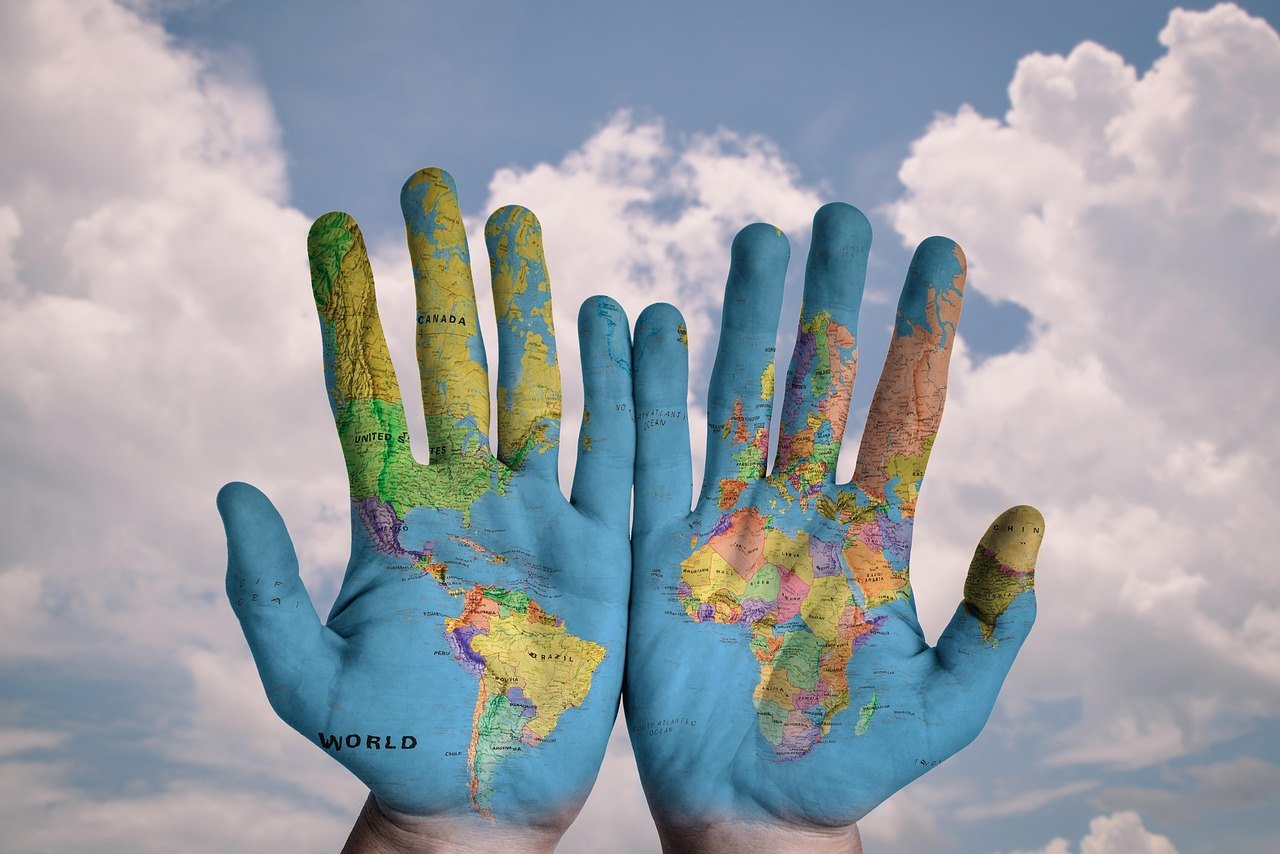 Hands painted with a map of the world